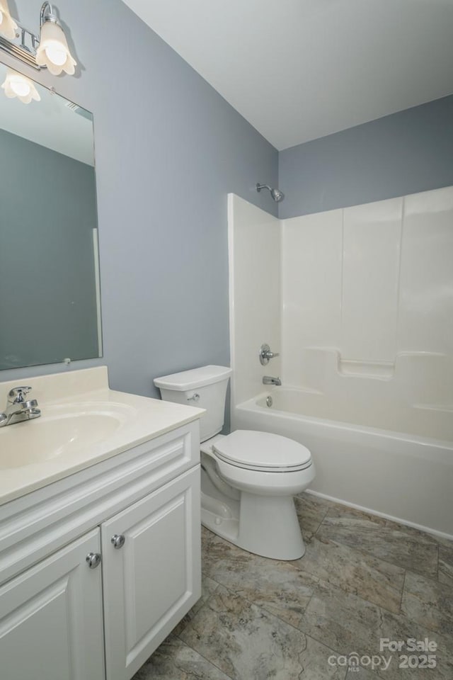 full bathroom featuring toilet, vanity, and tub / shower combination