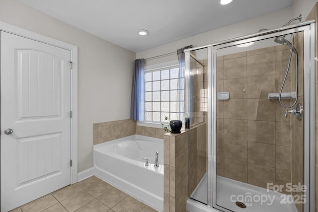 bathroom featuring tile patterned floors, a garden tub, and a shower stall