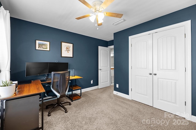 office area with visible vents, carpet flooring, a ceiling fan, and baseboards