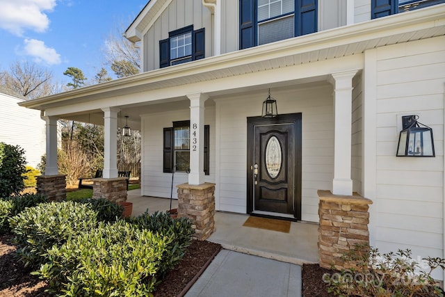 entrance to property with a porch and board and batten siding