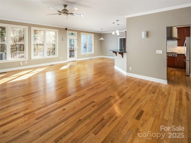 unfurnished living room with ornamental molding, ceiling fan, and light hardwood / wood-style flooring