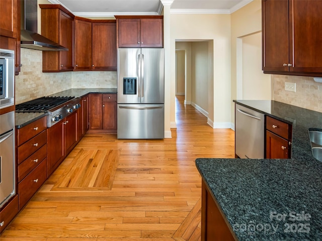 kitchen with light hardwood / wood-style flooring, appliances with stainless steel finishes, wall chimney exhaust hood, ornamental molding, and decorative backsplash