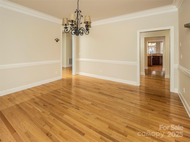 unfurnished dining area featuring a notable chandelier, ornamental molding, and light wood-type flooring