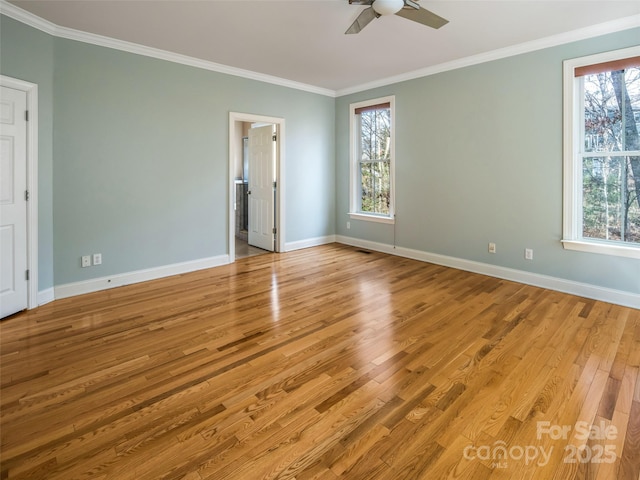 spare room with ceiling fan, ornamental molding, and light wood-type flooring