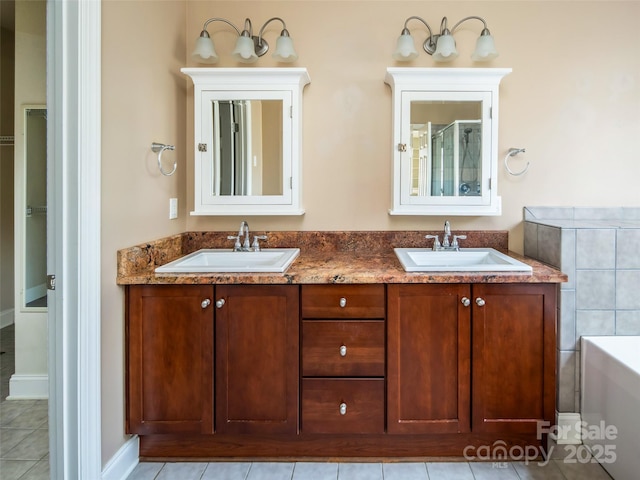 bathroom featuring vanity, a bathing tub, and tile patterned floors