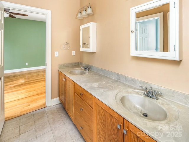 bathroom with ceiling fan, tile patterned flooring, and vanity