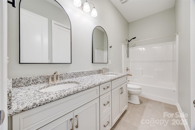 full bathroom with double vanity, tile patterned flooring, a sink, and toilet