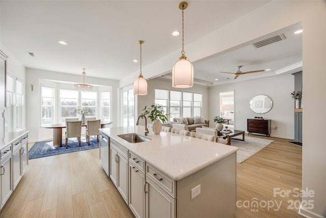 kitchen featuring light wood finished floors, recessed lighting, visible vents, stainless steel dishwasher, and a sink