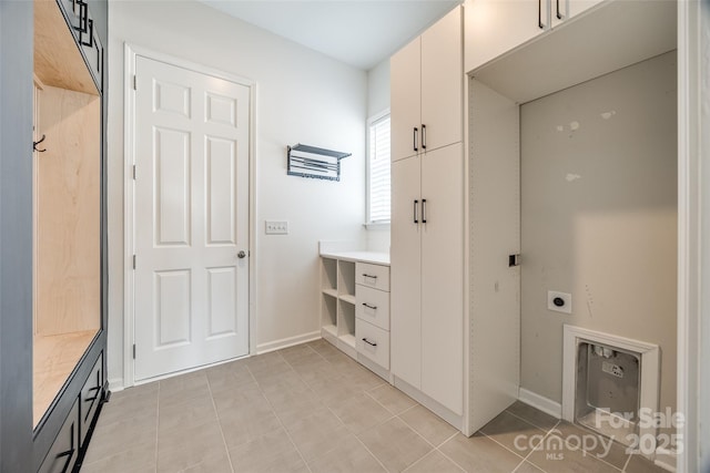 bathroom featuring tile patterned flooring, vanity, and baseboards