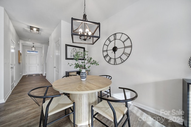 dining room featuring a chandelier and dark hardwood / wood-style floors