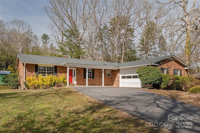 ranch-style house featuring an attached garage, brick siding, driveway, a front lawn, and a chimney