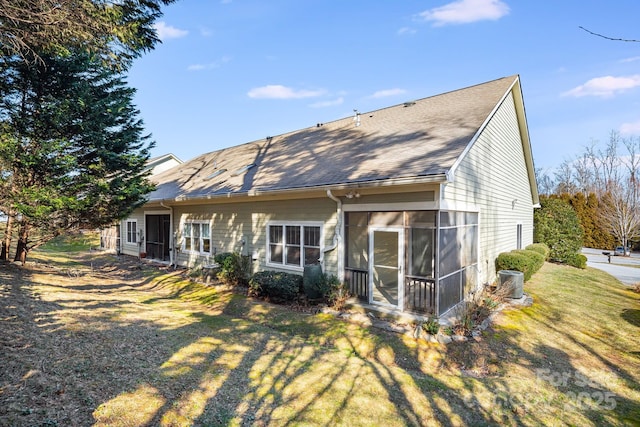 back of house featuring a sunroom and a yard