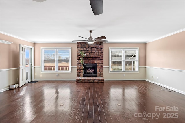 unfurnished living room featuring a fireplace, plenty of natural light, dark wood-type flooring, and ceiling fan