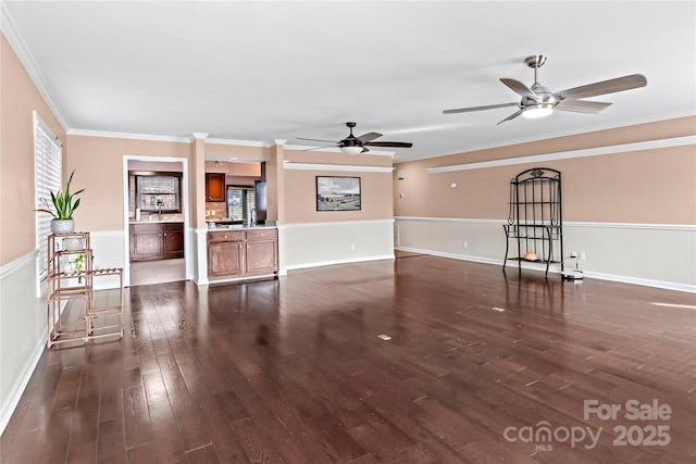 unfurnished living room featuring ceiling fan, ornamental molding, sink, and dark hardwood / wood-style flooring