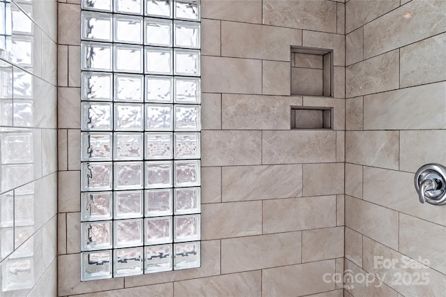 bathroom with a tile shower