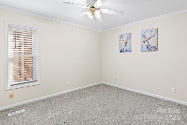 carpeted spare room featuring crown molding and ceiling fan