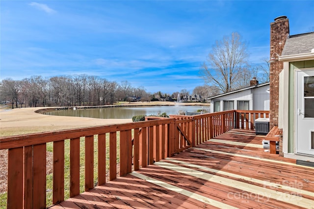 deck with a water view and central AC unit