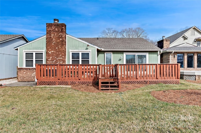 rear view of house featuring a yard and a wooden deck