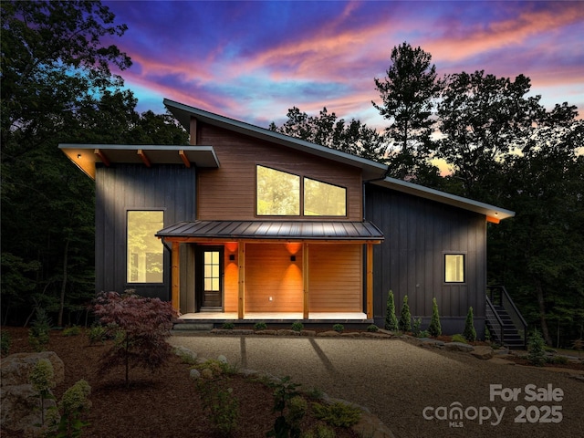 view of front of property with metal roof, board and batten siding, a standing seam roof, and a porch