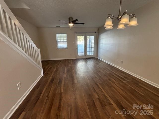 unfurnished living room with a textured ceiling, ceiling fan, french doors, and dark hardwood / wood-style floors