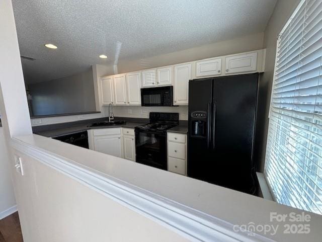 kitchen with white cabinetry, black appliances, a wealth of natural light, sink, and a textured ceiling