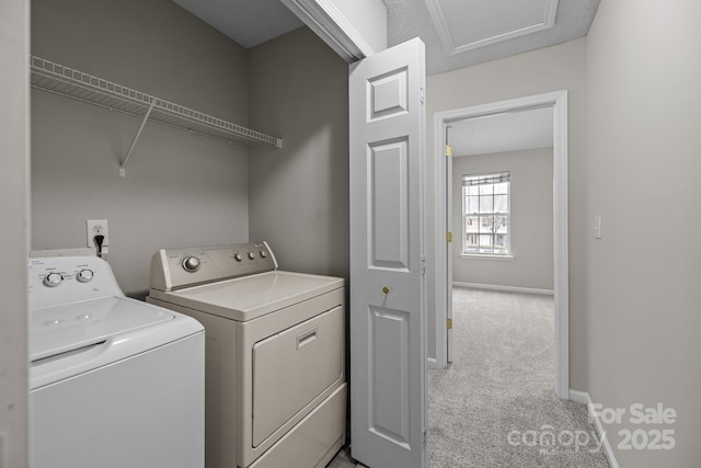 clothes washing area with laundry area, baseboards, separate washer and dryer, and light colored carpet