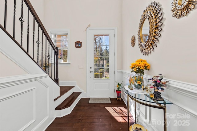 entryway with dark hardwood / wood-style flooring