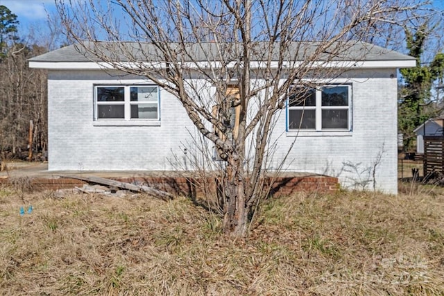 view of side of property featuring brick siding