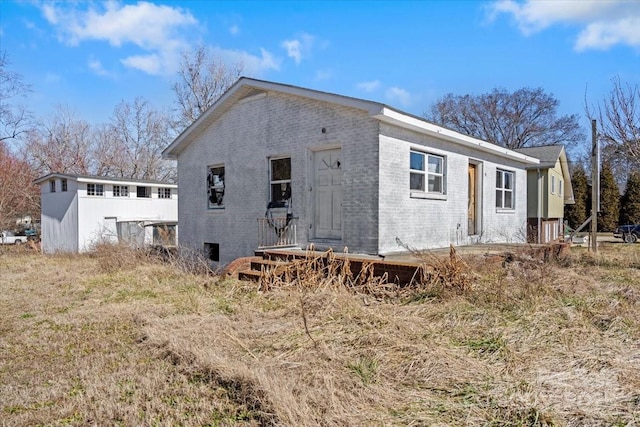 rear view of property with brick siding