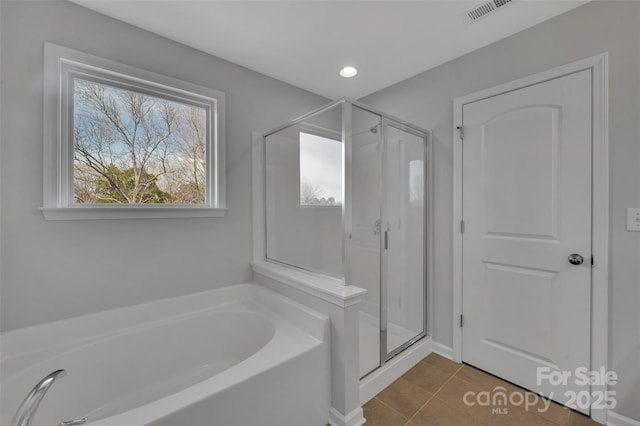 bathroom featuring shower with separate bathtub and tile patterned flooring