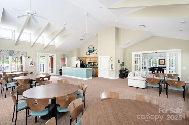 dining room with high vaulted ceiling, french doors, ceiling fan, and light colored carpet