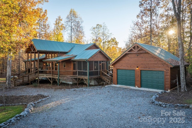 cabin with a garage and a sunroom