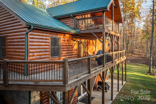 exterior space with a deck and a lawn