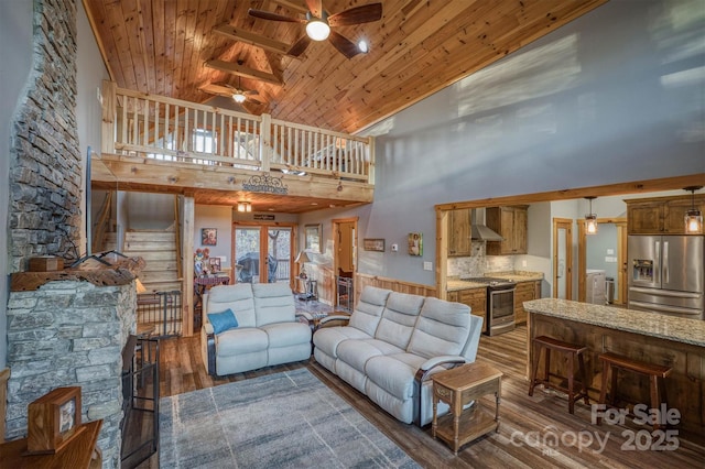 living room with ceiling fan, high vaulted ceiling, wood ceiling, dark hardwood / wood-style flooring, and washer / clothes dryer