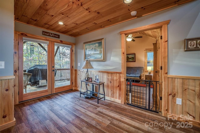 interior space featuring hardwood / wood-style flooring, wooden walls, wooden ceiling, and french doors