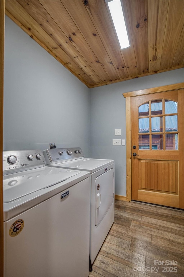 washroom with washer and dryer, light wood-type flooring, and wood ceiling