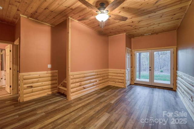 unfurnished room with wood-type flooring, french doors, log walls, ceiling fan, and wooden ceiling