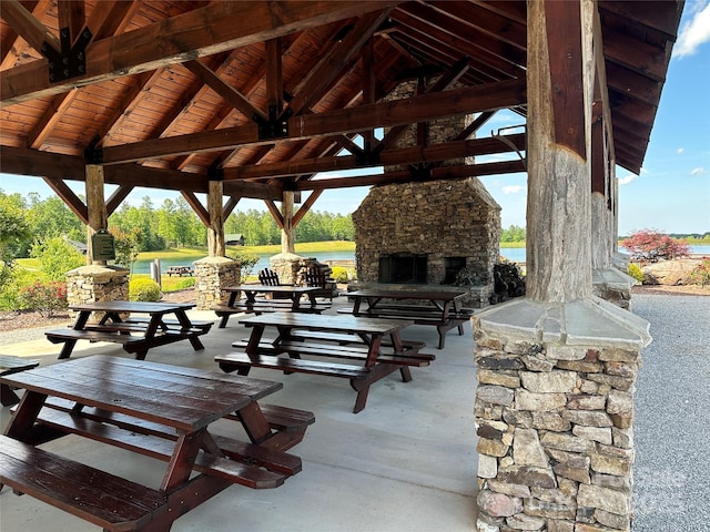 view of community featuring a patio area, a water view, and a gazebo