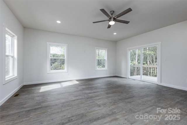 empty room with visible vents, baseboards, dark wood finished floors, and recessed lighting