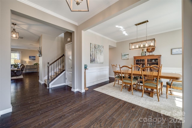 dining space with baseboards, wainscoting, dark wood-style floors, stairway, and crown molding