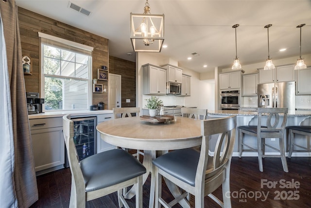 dining space with dark wood-type flooring, wine cooler, visible vents, and recessed lighting