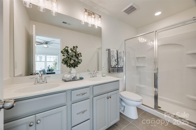 bathroom featuring a stall shower, tile patterned flooring, visible vents, and a sink