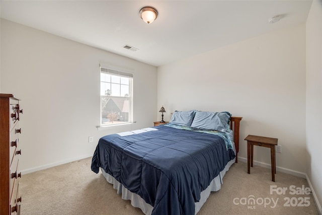 bedroom featuring visible vents, light carpet, and baseboards