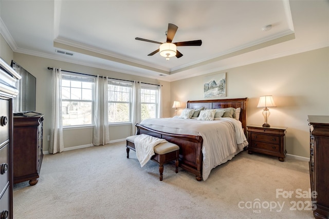 bedroom with baseboards, visible vents, a raised ceiling, light colored carpet, and crown molding