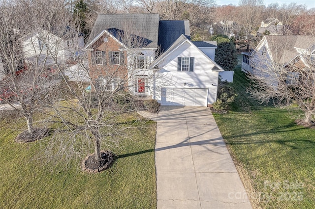 view of property featuring a front lawn and a garage