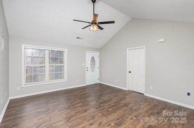 spare room featuring baseboards, visible vents, vaulted ceiling, and dark wood-style flooring