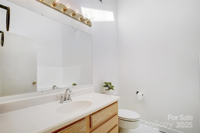 bathroom featuring toilet and vanity