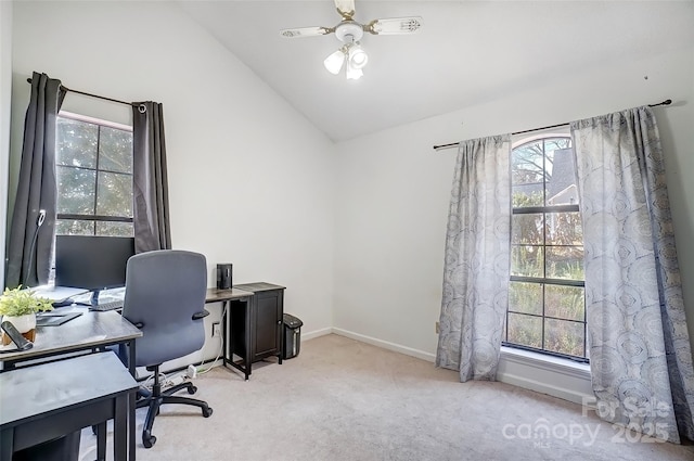 office space featuring lofted ceiling, ceiling fan, baseboards, and light colored carpet