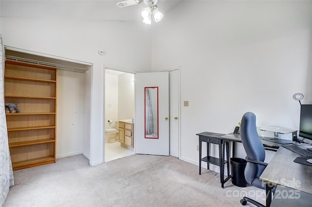 office space featuring light carpet, lofted ceiling, and a ceiling fan