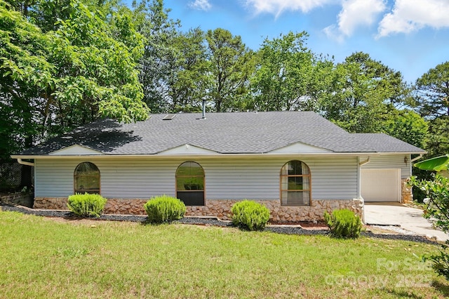 1205 Molokai Dr, Tega Cay, SC 29708 - view of front of house with stone siding, a garage, a front yard, driveway, and a shingled roof